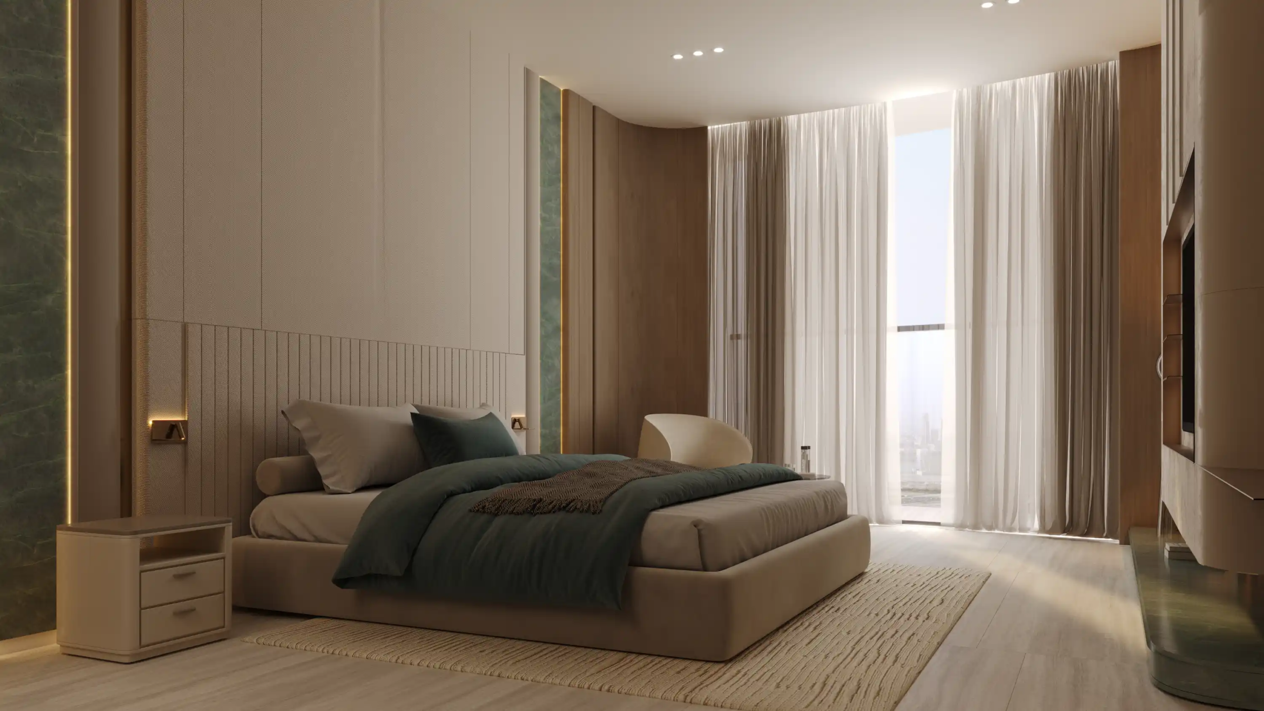 A modern bedroom at Binghatti Aquarise features a low beige bed, dark green bedding, light wood floors, a soft rug, small nightstand, white chair, large windows with sheer curtains, and neutral-toned walls bathed in natural light.