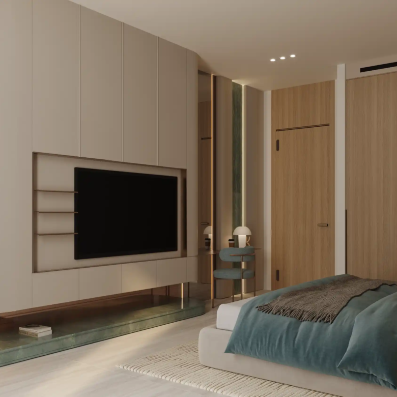 Minimalist modern bedroom at Binghatti Aquarise featuring a large wall-mounted TV, wood-paneled walls, a low bed with teal and gray bedding, a small side table, a decorative lamp, and soft ambient lighting.