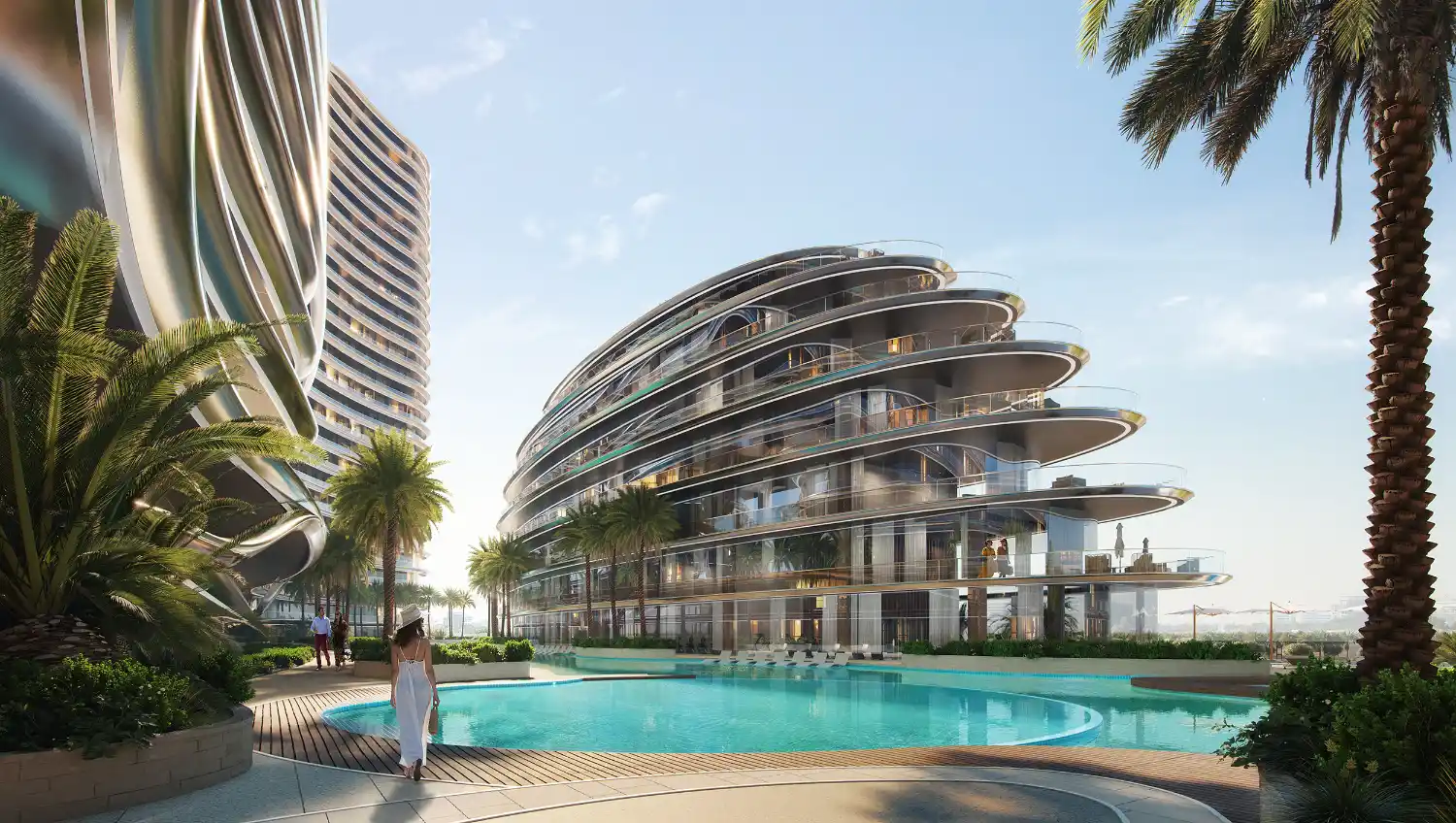 A futuristic, curved glass building—Binghatti Aquarise—with multiple balconies overlooks a circular swimming pool, surrounded by palm trees. A person in white walks near the pool in this tropical, modern setting.