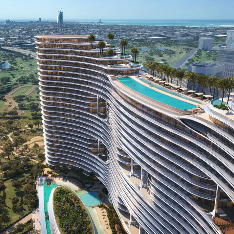 A modern, curved high-rise building—Binghatti Aquarise—with rooftop pools and palm trees overlooks a cityscape and coastline, with another iconic sail-shaped building visible in the distance.