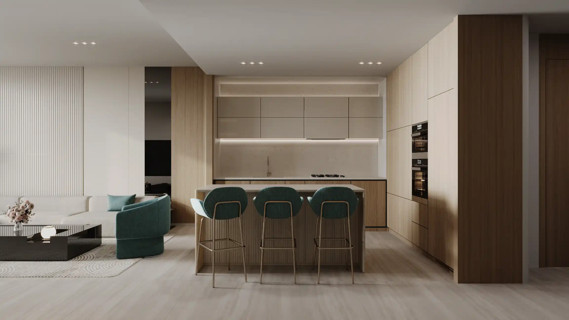 Modern kitchen with light wood cabinets, a central island with three teal barstools, built-in ovens, and minimalistic decor—reflecting the elegant style of Binghatti Aquarise. Open living area with teal sofa on the left. Soft, neutral tones throughout.