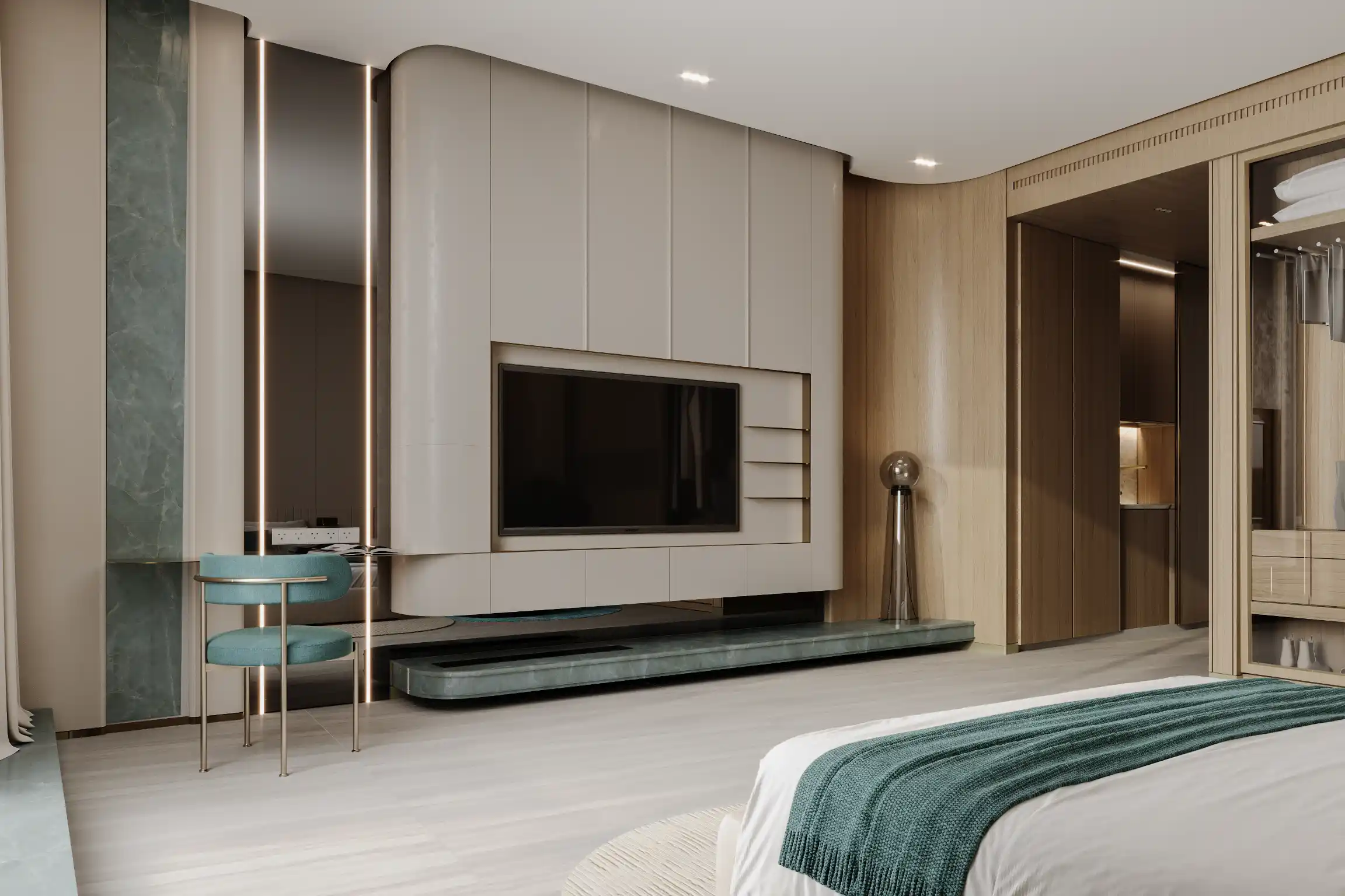 Modern bedroom at Binghatti Aquarise with built-in TV wall unit, teal accent chair at a small desk, wood paneling, and a neatly made bed with green accents. The space is minimalistic and well-lit.