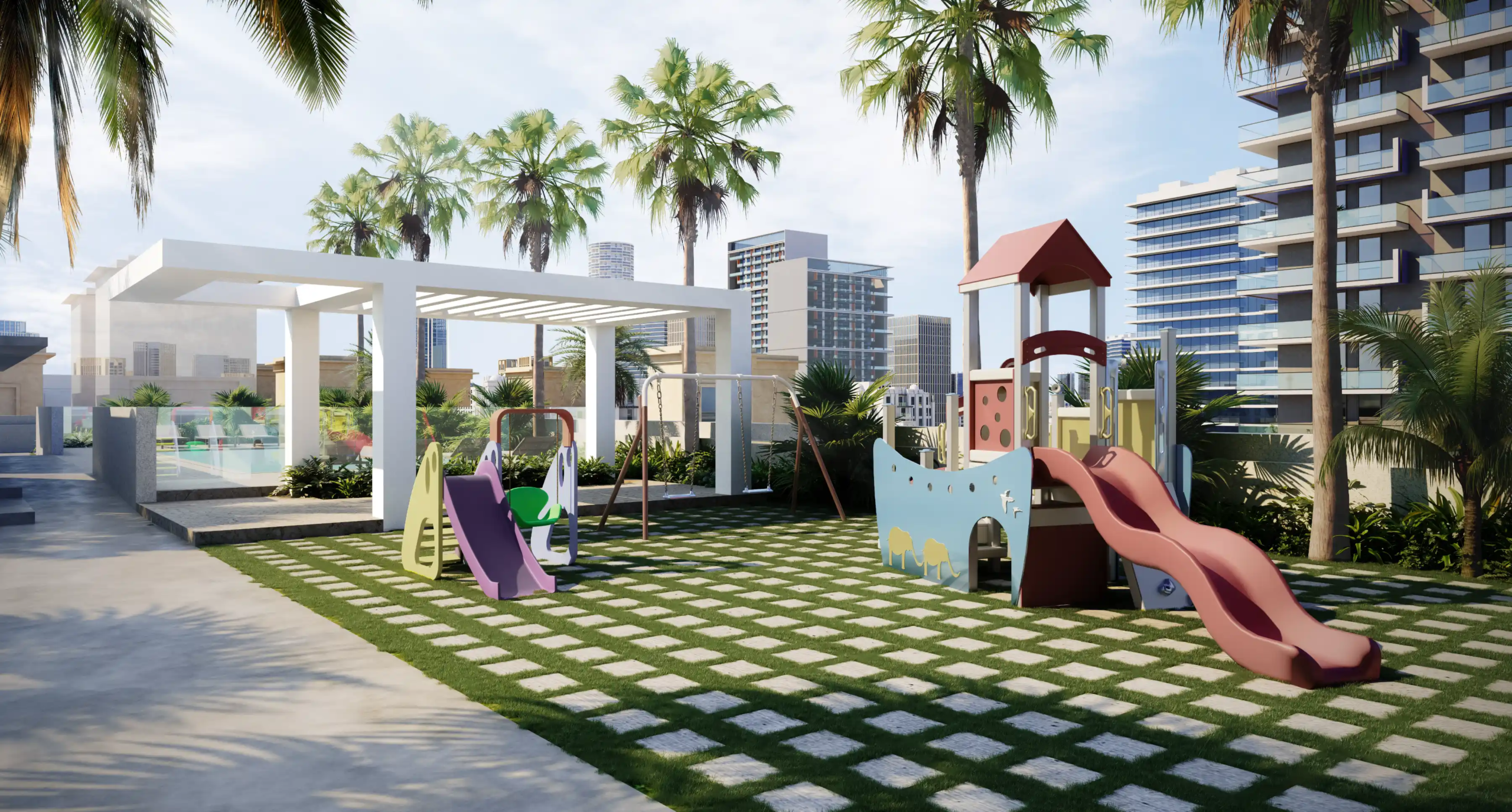 A modern outdoor playground with slides, swings, and climbing equipment on grass, set beneath palm trees and the striking Binghatti Apex and other tall city buildings under a partly cloudy sky.