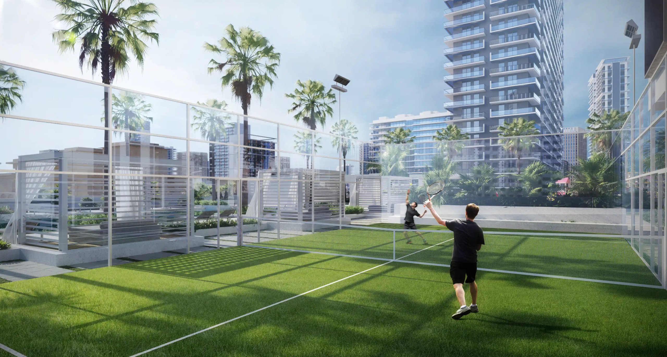 Two people play tennis on an outdoor court surrounded by palm trees and the striking Binghatti Apex high-rise buildings under a clear sky.
